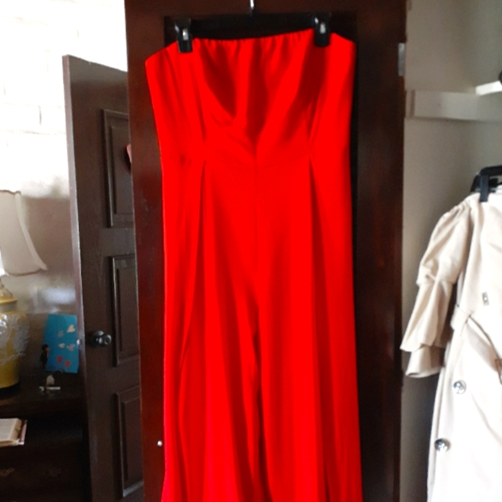 Gabrielle Union red strapless jumpsuit with skirt detailing.